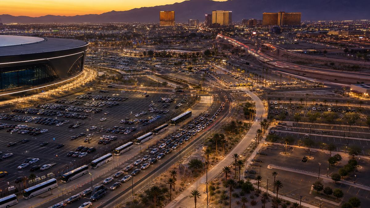 Illustrative aerial of event parking, rideshare staging and service roads beside a Las Vegas venue at dusk